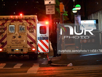 An ambulance is attending to the two female victims at the crime scene. Two females are being pushed onto the New York City subway platform...