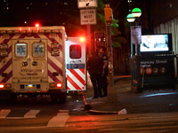 An ambulance is attending to the two female victims at the crime scene. Two females are being pushed onto the New York City subway platform...