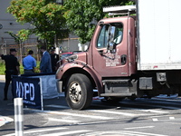 An unidentified male is riding a two-wheel device and is struck and killed by a white box truck in Queens, New York, United States, on Augus...