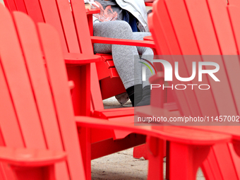 A person is napping on seating in Garden Square in downtown Brampton, Ontario, on August 5, 2024. (