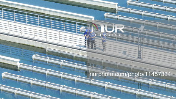 Workers are inspecting various water supply equipment at Qinghong Water Plant in Qianyuan town, Deqing County, Huzhou city, Zhejiang provinc...