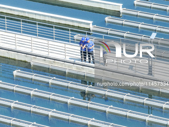 Workers are inspecting various water supply equipment at Qinghong Water Plant in Qianyuan town, Deqing County, Huzhou city, Zhejiang provinc...