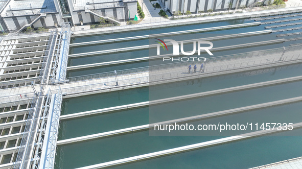 Workers are inspecting various water supply equipment at Qinghong Water Plant in Qianyuan town, Deqing County, Huzhou city, Zhejiang provinc...