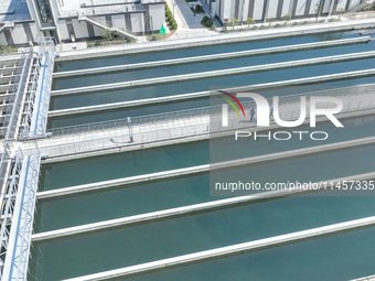 Workers are inspecting various water supply equipment at Qinghong Water Plant in Qianyuan town, Deqing County, Huzhou city, Zhejiang provinc...