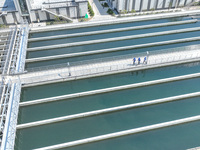 Workers are inspecting various water supply equipment at Qinghong Water Plant in Qianyuan town, Deqing County, Huzhou city, Zhejiang provinc...