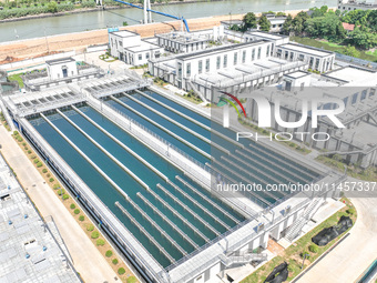 Workers are inspecting various water supply equipment at Qinghong Water Plant in Qianyuan town, Deqing County, Huzhou city, Zhejiang provinc...