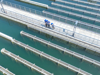 Workers are inspecting various water supply equipment at Qinghong Water Plant in Qianyuan town, Deqing County, Huzhou city, Zhejiang provinc...