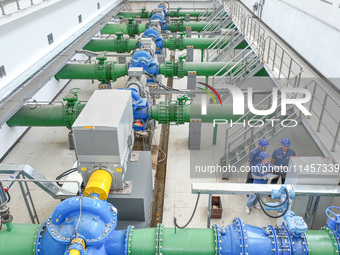 Workers are inspecting various water supply equipment at Qinghong Water Plant in Qianyuan town, Deqing County, Huzhou city, Zhejiang provinc...