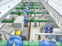 Workers are inspecting various water supply equipment at Qinghong Water Plant in Qianyuan town, Deqing County, Huzhou city, Zhejiang provinc...