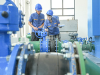 Workers are inspecting various water supply equipment at Qinghong Water Plant in Qianyuan town, Deqing County, Huzhou city, Zhejiang provinc...