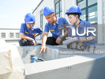 Workers are inspecting various water supply equipment at Qinghong Water Plant in Qianyuan town, Deqing County, Huzhou city, Zhejiang provinc...