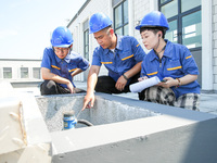 Workers are inspecting various water supply equipment at Qinghong Water Plant in Qianyuan town, Deqing County, Huzhou city, Zhejiang provinc...