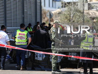 Israeli first responders are working at the site of a stabbing at the checkpoint outside of Jerusalem, Israel, on August 6, 2024, following...