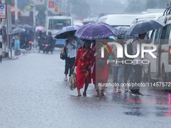 People are wading through flooded roads in Kathmandu, Nepal, on August 6, 2024. Nepal's Meteorological Forecasting Division (MFD) under the...