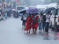 People are wading through flooded roads in Kathmandu, Nepal, on August 6, 2024. Nepal's Meteorological Forecasting Division (MFD) under the...