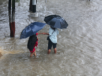 People are wading through flooded roads in Kathmandu, Nepal, on August 6, 2024. Nepal's Meteorological Forecasting Division (MFD) under the...