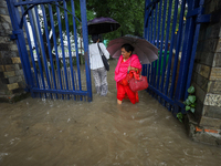 People are wading through flooded roads in Kathmandu, Nepal, on August 6, 2024. Nepal's Meteorological Forecasting Division (MFD) under the...