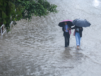 People are wading through flooded roads in Kathmandu, Nepal, on August 6, 2024. Nepal's Meteorological Forecasting Division (MFD) under the...