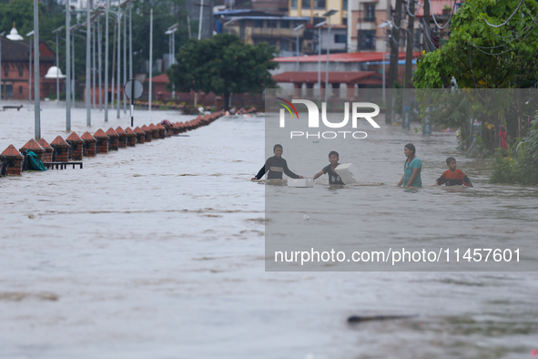 Children are wading through a flooded area on the embankments of Bagmati River in Teku, Kathmandu, Nepal, on August 6, 2024. Nepal's Meteoro...