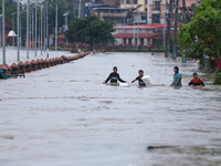 Children are wading through a flooded area on the embankments of Bagmati River in Teku, Kathmandu, Nepal, on August 6, 2024. Nepal's Meteoro...