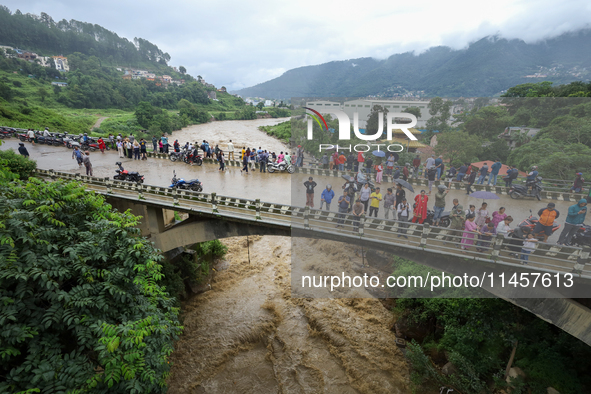 People are watching the flooded Bagmati River at Chovar in Kathmandu, Nepal, on August 6, 2024. Nepal's Meteorological Forecasting Division...