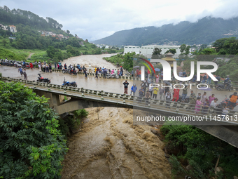 People are watching the flooded Bagmati River at Chovar in Kathmandu, Nepal, on August 6, 2024. Nepal's Meteorological Forecasting Division...