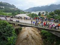 People are watching the flooded Bagmati River at Chovar in Kathmandu, Nepal, on August 6, 2024. Nepal's Meteorological Forecasting Division...