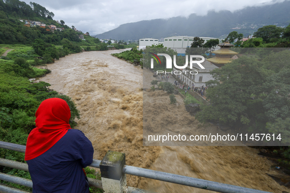 People are watching the flooded Bagmati River at Chovar in Kathmandu, Nepal, on August 6, 2024. Nepal's Meteorological Forecasting Division...