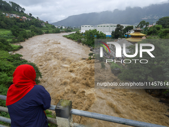 People are watching the flooded Bagmati River at Chovar in Kathmandu, Nepal, on August 6, 2024. Nepal's Meteorological Forecasting Division...