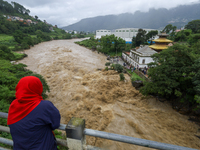 People are watching the flooded Bagmati River at Chovar in Kathmandu, Nepal, on August 6, 2024. Nepal's Meteorological Forecasting Division...