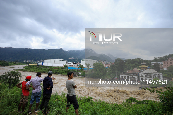 People are watching the flooded Bagmati River at Chovar in Kathmandu, Nepal, on August 6, 2024. Nepal's Meteorological Forecasting Division...