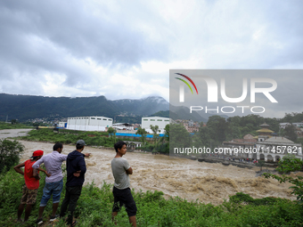 People are watching the flooded Bagmati River at Chovar in Kathmandu, Nepal, on August 6, 2024. Nepal's Meteorological Forecasting Division...