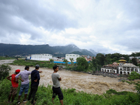 People are watching the flooded Bagmati River at Chovar in Kathmandu, Nepal, on August 6, 2024. Nepal's Meteorological Forecasting Division...