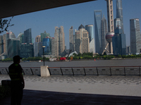 A security worker is protecting under the shadow in North Bund, Shanghai, China, on August 6, 2024. (