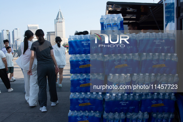 A vendor is selling water at Bund in Shanghai, China, on August 6, 2024. 