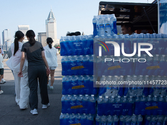 A vendor is selling water at Bund in Shanghai, China, on August 6, 2024. (