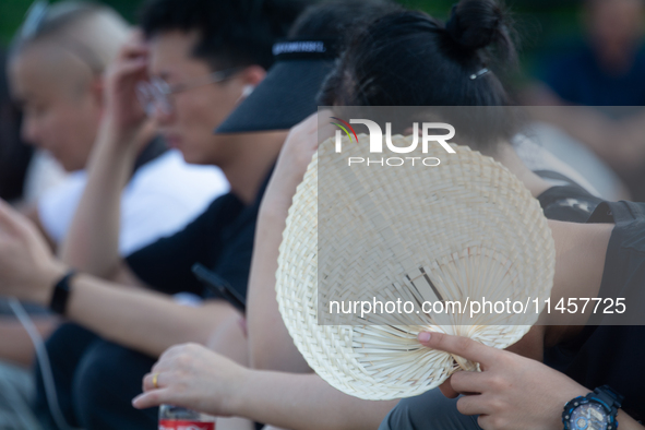 People are resting at the Bund in Shanghai, China, on August 6, 2024. 