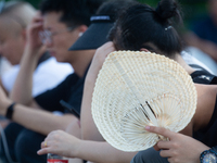 People are resting at the Bund in Shanghai, China, on August 6, 2024. (