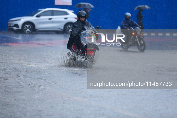 Vehicles are wading through the flooded streets of Kathmandu, Nepal, on August 6, 2024. Nepal's Meteorological Forecasting Division (MFD) un...