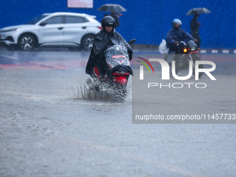 Vehicles are wading through the flooded streets of Kathmandu, Nepal, on August 6, 2024. Nepal's Meteorological Forecasting Division (MFD) un...