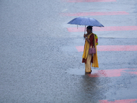 A Nepali woman is wading through flooded roads in Kathmandu, Nepal, on August 6, 2024. Nepal's Meteorological Forecasting Division (MFD) und...