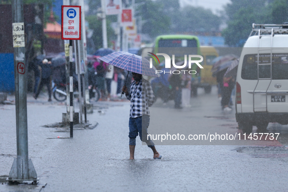 A man is wading through flooded roads in Kathmandu, Nepal, on August 6, 2024. Nepal's Meteorological Forecasting Division (MFD) under the De...