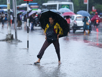 A woman is wading through flooded roads in Kathmandu, Nepal, on August 6, 2024. Nepal's Meteorological Forecasting Division (MFD) under the...