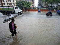 People are wading through flooded roads in Kathmandu, Nepal, on August 6, 2024. Nepal's Meteorological Forecasting Division (MFD) under the...