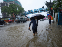 People are wading through flooded roads in Kathmandu, Nepal, on August 6, 2024. Nepal's Meteorological Forecasting Division (MFD) under the...