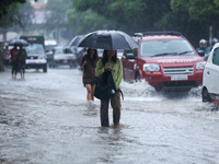 People are wading through flooded roads in Kathmandu, Nepal, on August 6, 2024. Nepal's Meteorological Forecasting Division (MFD) under the...