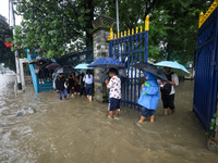 People are wading through flooded roads in Kathmandu, Nepal, on August 6, 2024. Nepal's Meteorological Forecasting Division (MFD) under the...