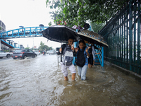 People are wading through flooded roads in Kathmandu, Nepal, on August 6, 2024. Nepal's Meteorological Forecasting Division (MFD) under the...