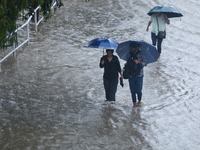 People are wading through flooded roads in Kathmandu, Nepal, on August 6, 2024. Nepal's Meteorological Forecasting Division (MFD) under the...