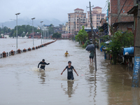 Children are wading through a flooded area on the embankments of Bagmati River in Teku, Kathmandu, Nepal, on August 6, 2024. Nepal's Meteoro...